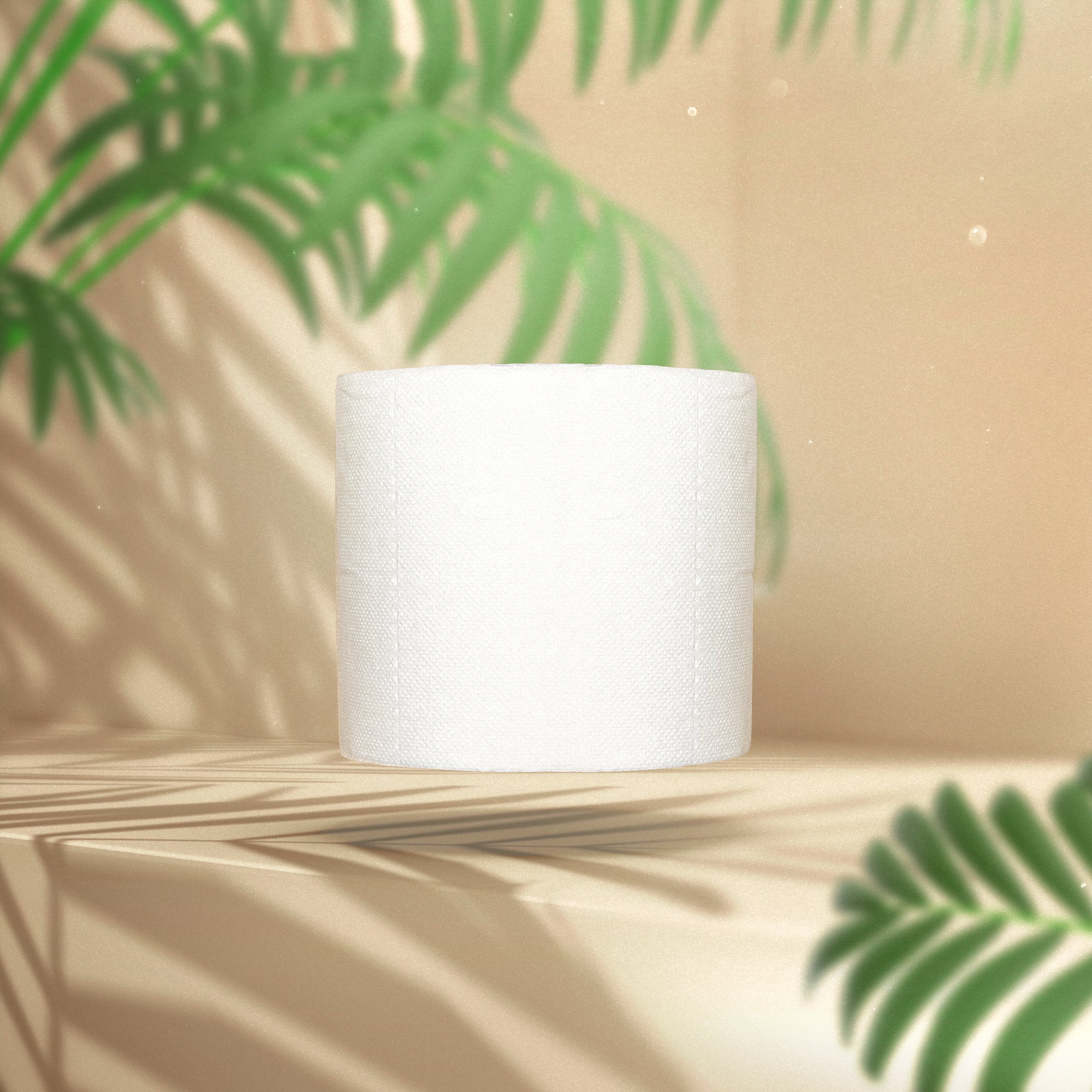 Sample organic 3-ply bamboo toilet paper roll on a beige background with green leaves